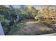 Screened in view of a backyard featuring a black iron fence and lush green landscaping at 1445 Creekside Cir, Winter Springs, FL 32708