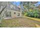 Backyard view of the home featuring a patio, sliding glass doors, and lush, private landscaping at 1445 Creekside Cir, Winter Springs, FL 32708