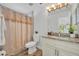 Bathroom featuring granite vanity, shower with decorative shower curtain, with wood look flooring and ample natural light at 1445 Creekside Cir, Winter Springs, FL 32708