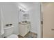 Well-lit bathroom featuring a vanity with granite countertop, decorative mirrors, wood look flooring, and glass door shower at 1445 Creekside Cir, Winter Springs, FL 32708