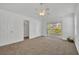 Spacious bedroom featuring neutral carpet, double door closet, ceiling fan, and sliding glass doors to an outdoor balcony at 1445 Creekside Cir, Winter Springs, FL 32708