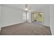 Open bedroom featuring neutral carpet, ceiling fan, and sliding doors to outdoor balcony at 1445 Creekside Cir, Winter Springs, FL 32708
