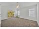An expansive bedroom featuring neutral carpet, a ceiling fan, and sliding glass doors leading to a balcony at 1445 Creekside Cir, Winter Springs, FL 32708