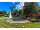 Tranquil community featuring a fountain, lush landscaping, and the Tusca Willa entrance sign at 1445 Creekside Cir, Winter Springs, FL 32708