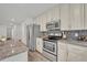 Well-equipped kitchen with stainless appliances, modern cabinetry, and sleek granite countertops at 1445 Creekside Cir, Winter Springs, FL 32708