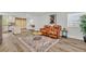 Open-concept living area with wood floors and a leather sofa set on a decorative area rug at 1445 Creekside Cir, Winter Springs, FL 32708
