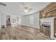 Bright living room featuring wood floors, fireplace, and abundant natural light from large windows at 1445 Creekside Cir, Winter Springs, FL 32708