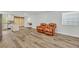 Open-concept living area with wood floors, natural light, and a leather sofa at 1445 Creekside Cir, Winter Springs, FL 32708
