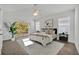 Bright main bedroom featuring a ceiling fan, neutral carpet, slider to balcony, and ample natural light from windows at 1445 Creekside Cir, Winter Springs, FL 32708