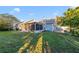 Spacious backyard with grassy lawn and screened porch at 250 Silas Phelps Ct, Orlando, FL 32828