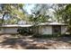 Ranch-style home with attached garage, nestled among mature trees at 2663 Magnolia Rd, Deland, FL 32720