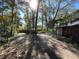 Side yard view with mature trees and a lamp post at 2663 Magnolia Rd, Deland, FL 32720