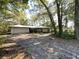 Ranch-style home with attached garage, surrounded by trees at 2663 Magnolia Rd, Deland, FL 32720