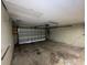 Garage with overhead door and storage shelving at 2663 Magnolia Rd, Deland, FL 32720