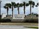 The Reserve at Twin Lakes community entrance with stonework and palm trees at 2813 Willowseed Ln, Saint Cloud, FL 34772