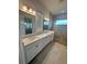 Elegant bathroom boasts double vanity, large shower, and modern fixtures at 2817 Willowseed Ln, Saint Cloud, FL 34772