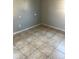 Spacious bedroom with tile flooring and neutral walls at 5465 Lescot Ln, Orlando, FL 32811