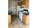 Efficient kitchen with white appliances and wood cabinets at 5465 Lescot Ln, Orlando, FL 32811