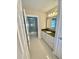 Well-lit bathroom featuring a walk-in shower and vanity with granite countertop and ample storage at 7652 Whisper Way # 104, Reunion, FL 34747
