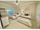 Inviting bedroom with two twin beds, neutral tones, and a ceiling fan, creating a cozy and comfortable space at 7652 Whisper Way # 104, Reunion, FL 34747