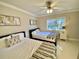 Charming bedroom with two beds, neutral colors, and a window offering natural light, creating a comfortable retreat at 7652 Whisper Way # 104, Reunion, FL 34747