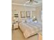 Bright bedroom with neutral decor, features tiled floors and ample natural light with a queen-sized bed at 7652 Whisper Way # 104, Reunion, FL 34747