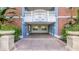 Building entrance with brick accents, blue doors, and a decorative balcony, creating a welcoming facade at 7652 Whisper Way # 104, Reunion, FL 34747