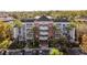 Beautiful three-story condominium complex with lush tropical landscaping, balconies, and convenient parking at 7652 Whisper Way # 104, Reunion, FL 34747