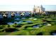 Picturesque golf course with lush green fairways, sand traps, and a luxury resort in the background at 7652 Whisper Way # 104, Reunion, FL 34747