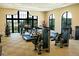 Well-equipped gym with treadmills, weights, and large windows offering a view of the outdoors at 7652 Whisper Way # 104, Reunion, FL 34747