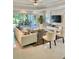 Bright and airy living room with tile floors, stylish furniture, and sliding glass doors to the patio at 7652 Whisper Way # 104, Reunion, FL 34747