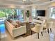 Bright and airy living room with tile floors, stylish furniture, and sliding glass doors to the patio at 7652 Whisper Way # 104, Reunion, FL 34747