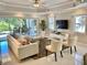 Bright and airy living room with tile floors, stylish furniture, and sliding glass doors to the patio at 7652 Whisper Way # 104, Reunion, FL 34747