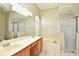 Bathroom featuring a double vanity, soaking tub, and glass-enclosed shower at 77 Spring Glen Dr, Debary, FL 32713