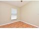 This bedroom has natural light and neutral walls, with wood-look laminate flooring and a light-colored trim at 77 Spring Glen Dr, Debary, FL 32713