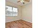 Cozy bedroom featuring wood floors and a large window at 77 Spring Glen Dr, Debary, FL 32713