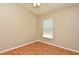 This bedroom has natural light and neutral walls, with wood-look laminate flooring and a light-colored trim at 77 Spring Glen Dr, Debary, FL 32713