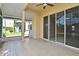 Enclosed lanai with tiled flooring and sliding glass doors offering serene water views at 77 Spring Glen Dr, Debary, FL 32713