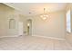 Spacious living room with tile flooring, high ceilings, and elegant chandelier at 77 Spring Glen Dr, Debary, FL 32713