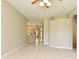 Open-concept living room with tile floors, showcasing the kitchen and an arched doorway in the background at 77 Spring Glen Dr, Debary, FL 32713