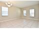 Spacious living room with neutral walls, tiled floors, and plenty of natural light from large windows at 77 Spring Glen Dr, Debary, FL 32713