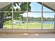 Screened-in lanai showcases a picturesque waterfront view, featuring a tranquil lake at 77 Spring Glen Dr, Debary, FL 32713