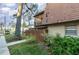 Brick townhouse with balcony, wooden fence, and landscaping at 159 Sweetgum Ln, Port Orange, FL 32129