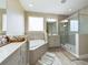 Elegant bathroom with soaking tub, walk-in shower, and modern vanity at 2506 Volunteer Ave, Kissimmee, FL 34744
