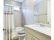 Bathroom with a shower/tub combo, white vanity, and gray tile at 2506 Volunteer Ave, Kissimmee, FL 34744