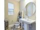 Small bathroom with pedestal sink and toilet at 2506 Volunteer Ave, Kissimmee, FL 34744