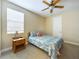 Cozy bedroom featuring a double bed and a wood nightstand at 2506 Volunteer Ave, Kissimmee, FL 34744
