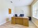 Home office with a large wooden desk, two computer monitors, and a corkboard at 2506 Volunteer Ave, Kissimmee, FL 34744