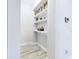Laundry room with built-in shelves and hooks for storage at 2506 Volunteer Ave, Kissimmee, FL 34744