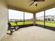 Large screened porch with exercise bike and backyard view at 2506 Volunteer Ave, Kissimmee, FL 34744
